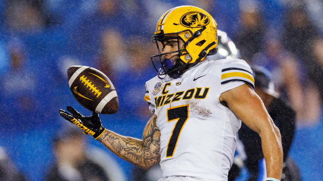 Oct 14, 2023; Lexington, Kentucky, USA; Missouri Tigers running back Cody Schrader (7) tosses the ball to a referee after scoring a touchdown during the fourth quarter against the Kentucky Wildcats at Kroger Field. Mandatory Credit: Jordan Prather-USA TODAY Sports